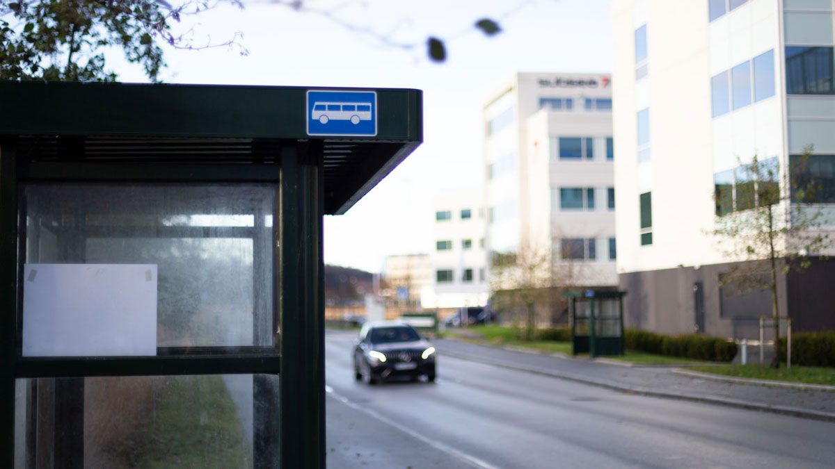 Busstopp utenfor en kontorbygning.