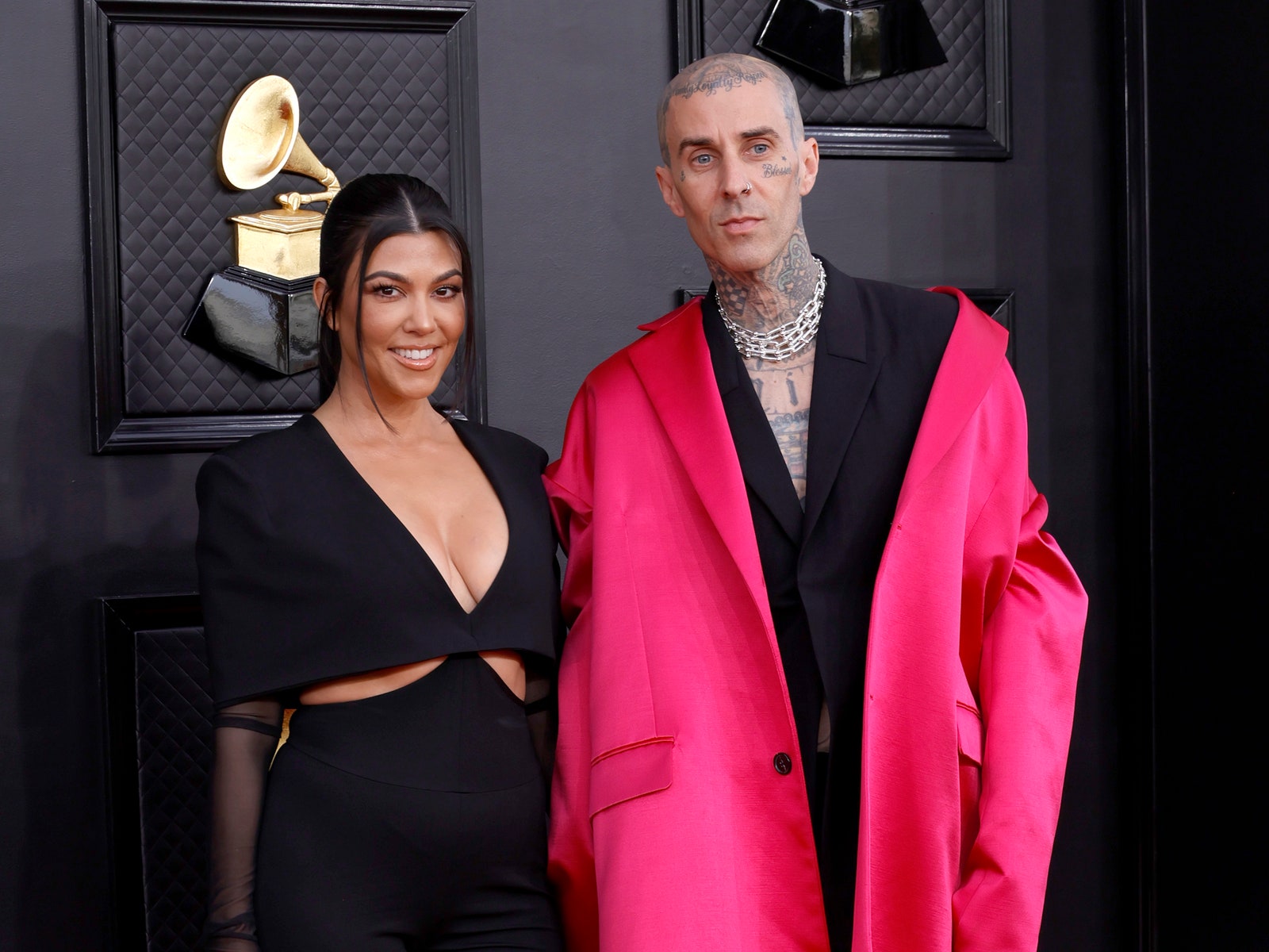 Image may contain Coat Clothing Apparel Kourtney Kardashian Travis Barker Human Person Footwear Shoe and Overcoat