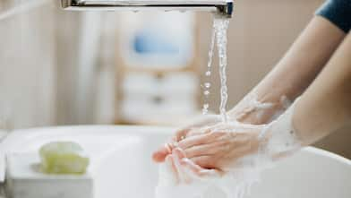 Woman washing her hands in the sink