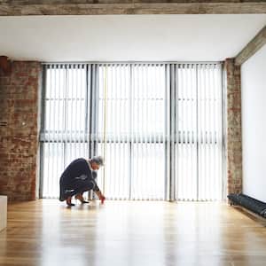 Woman measuring the square footage of a room