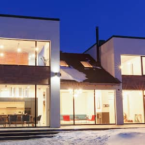 House lit up on snowy night