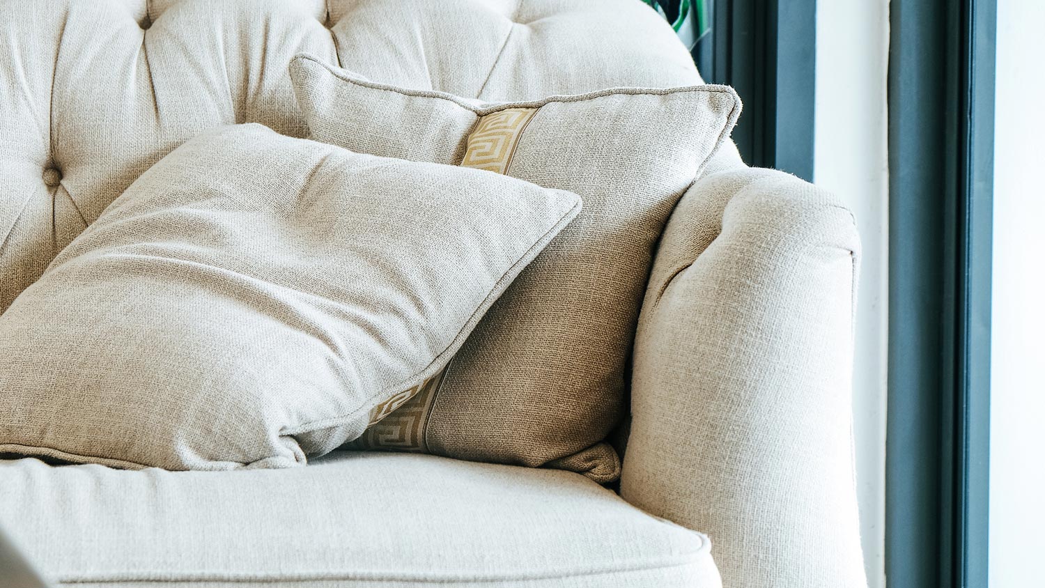 A bright linen sofa with matching cushions