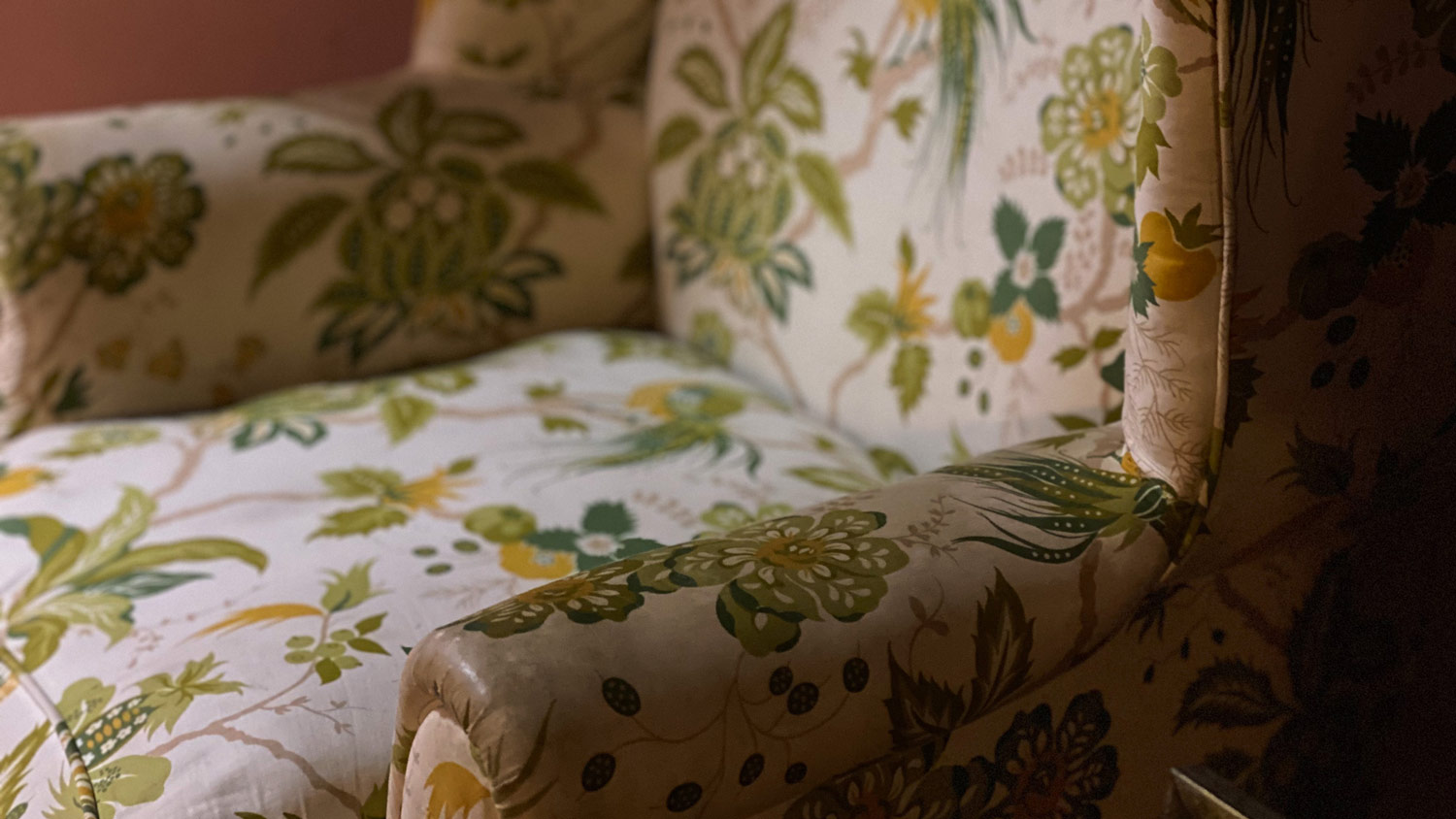 A chair with a flower pattern on its synthetic fabric