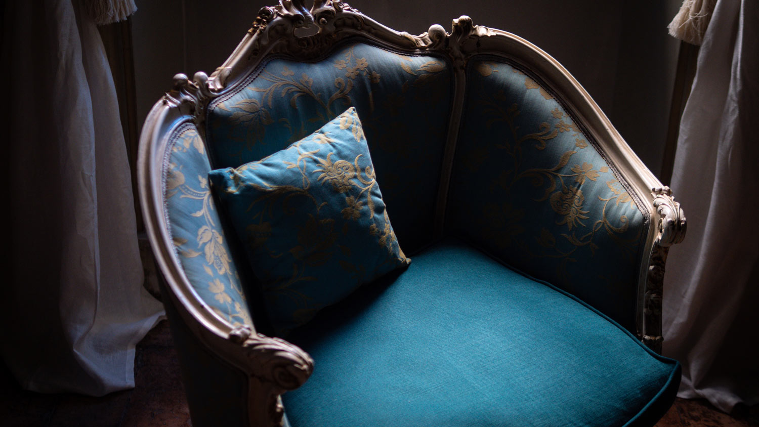 A vintage chair with upholstered silk fabric