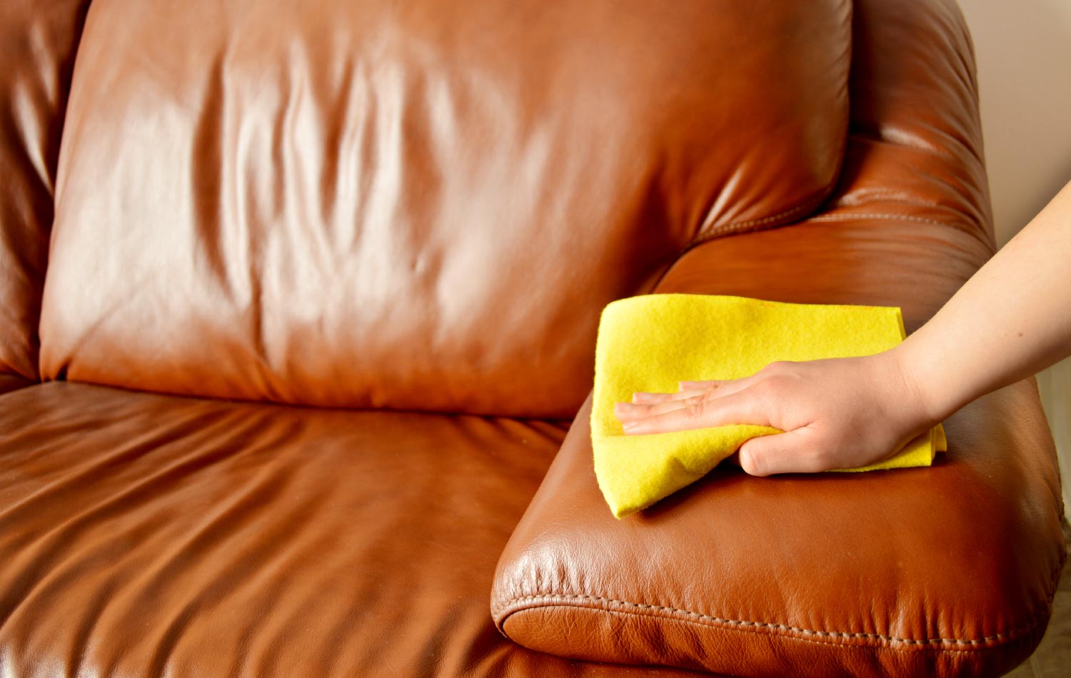 Cleaning a brown sofa manually