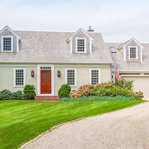 beige house with gravel driveway