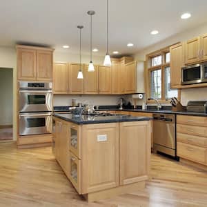 A large kitchen with unfinished oak cabinets