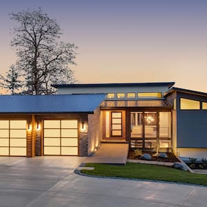 The exterior of an illuminated contemporary house at dusk