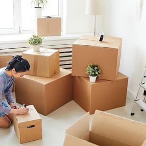 Woman packing her belongings in boxes