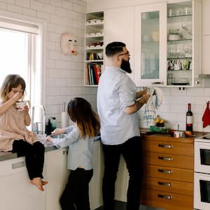 Father and daughter cleaning kitchen