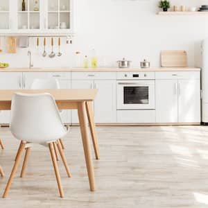 A Scandinavian kitchen with shelves and a wooden table