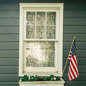 Window box with an American flag outside a house