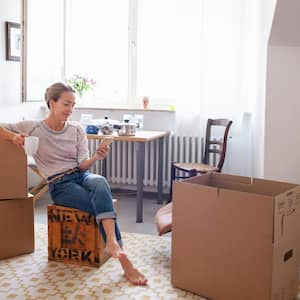 A woman taking a coffee break while moving house