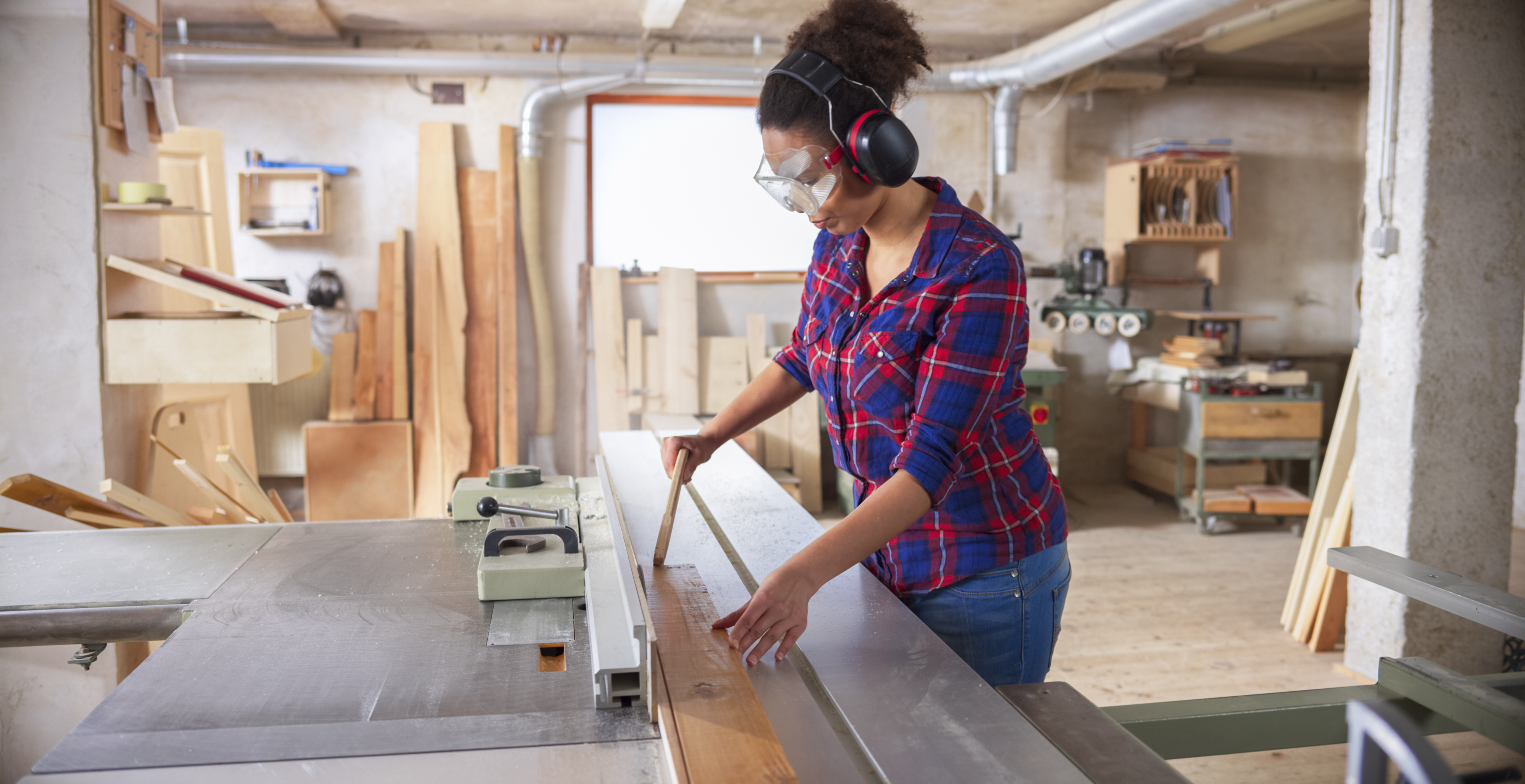 A female construction worker wearing safety glasses