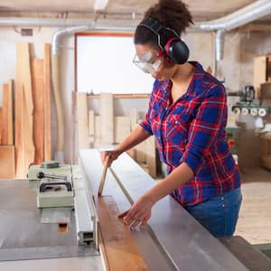 A female construction worker wearing safety glasses