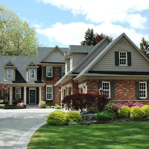 House with brick on lower and grey siding on upper