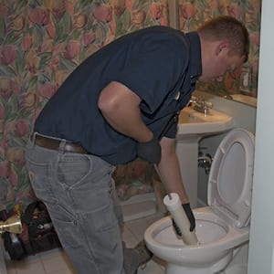 plumber working in a toilet