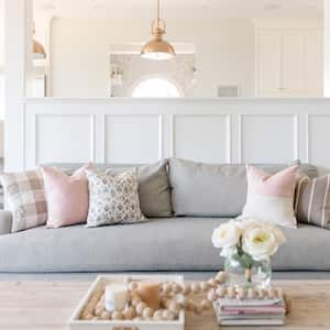 A bright sitting room with the kitchen in the background