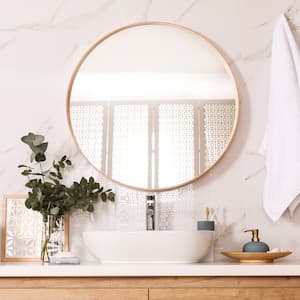 A bathroom vanity with a round mirror