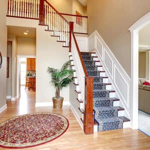 Beautiful interior of hardwood floor leading up to staircase.