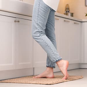 woman standing on kitchen rug in front of sink