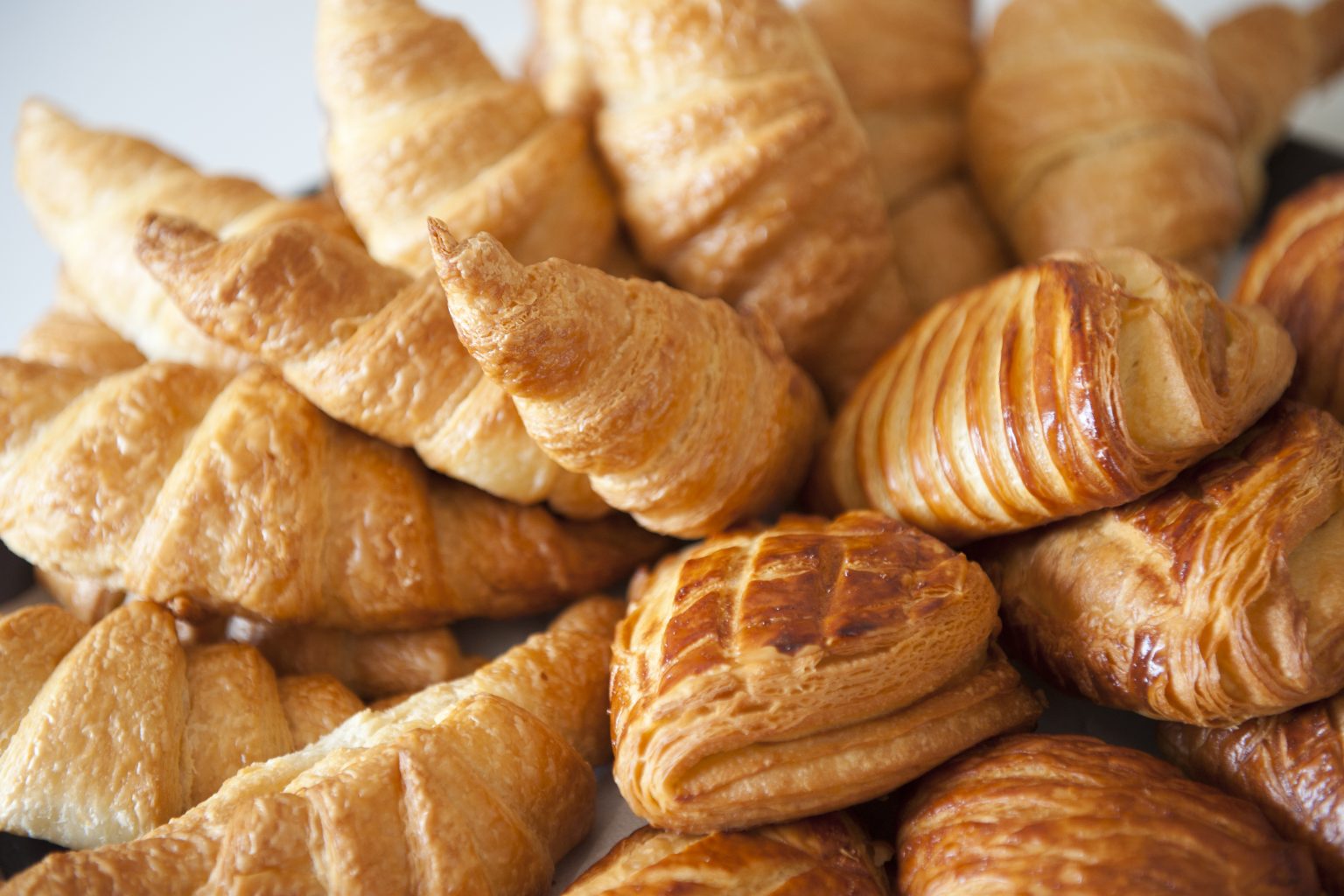 Assorted croissants, brioche, and pastries