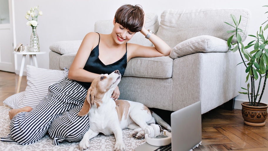 woman hanging out with dog in living room  