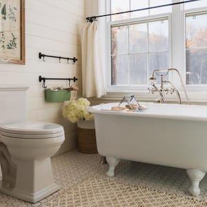 A bathroom with a white bathtub and tiled floor