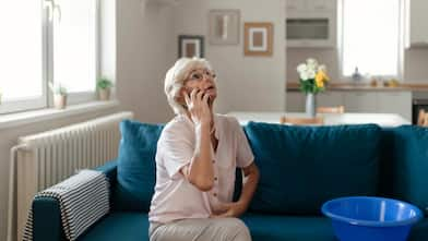 A woman calling a plumber for water leakage