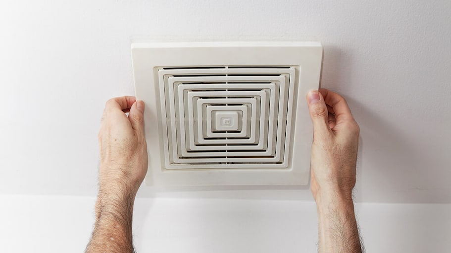 Person installing a fan cover