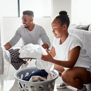  A couple doing laundry together at home