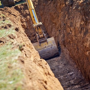 Excavator digging a trench