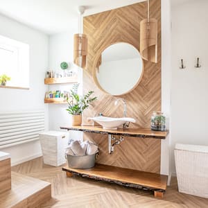 A boho style bathroom with a wooden vanity