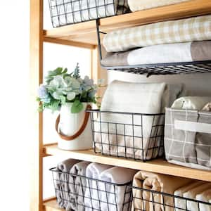 Wire baskets on a wooden bookshelf