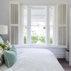 Bedroom with shutters at window