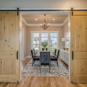 Modern dining room with a double barn door entrance