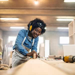 A woman working as a carpenter in her workshop