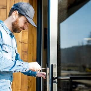  A locksmith repairing a door lock