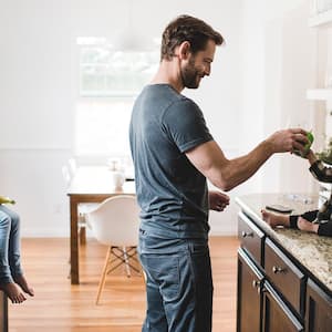 Father feeding kid on granite counters