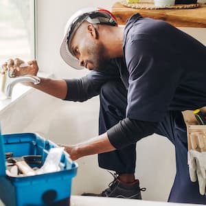 A plumber checks pipes