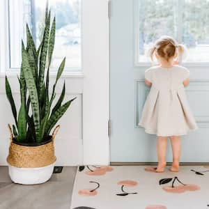 A little girl looking out of the door in a modern, bright house