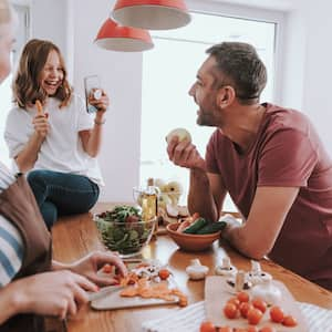 A family of three by the kitchen island in a bright kitchen