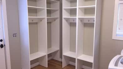 Open storage closets in a laundry room.