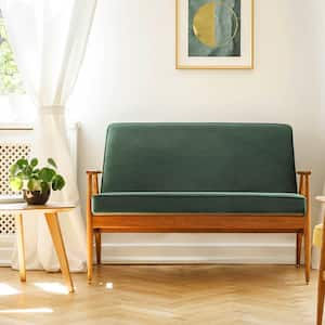 a midcentury modern style sofa in a loft style livingroom with wood accents, a wood wall, and hanging lighting