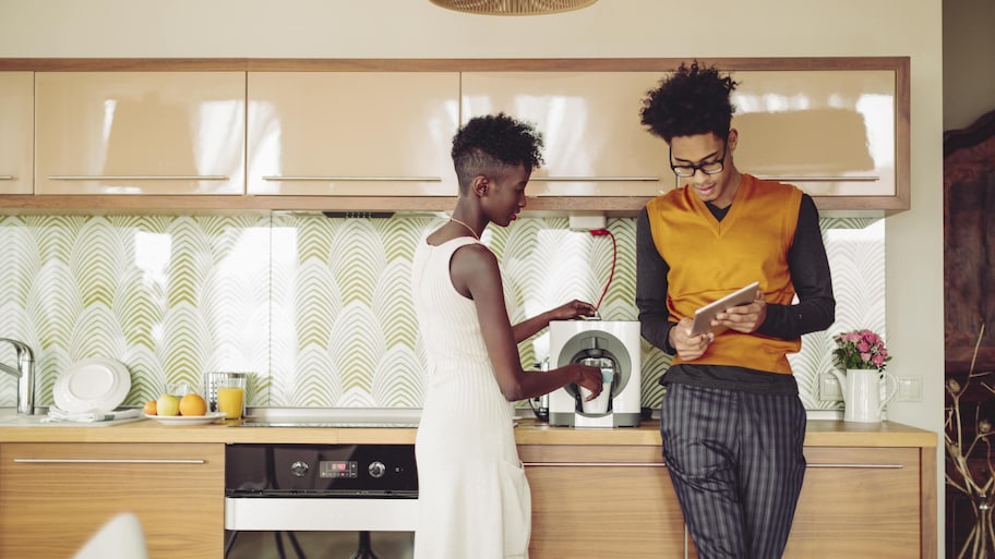 Couple making coffee in kitchen 