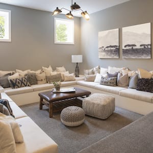 A finished basement with a lounge area