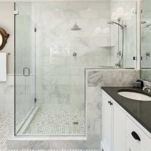 A master bathroom with a glass shower and a white bathtub