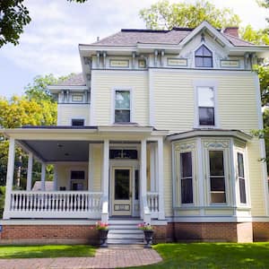 Two story historical home exterior with a bay window