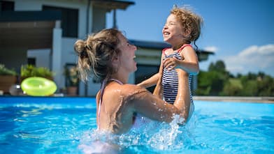 mother and child playing in the swimming pool