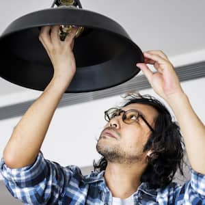 A man changing a light bulb